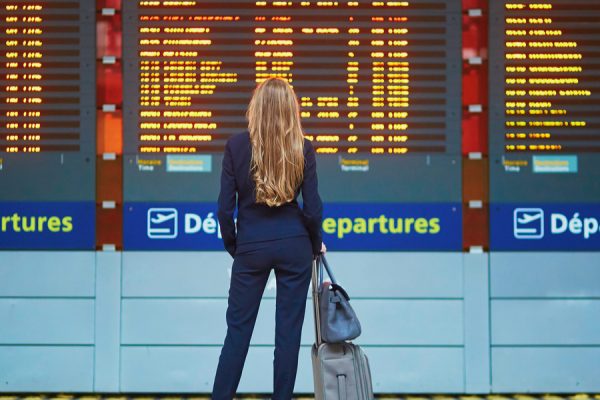 Women reading flight schedule