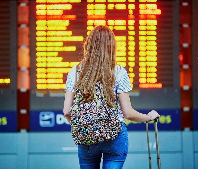 woman looking at airport board