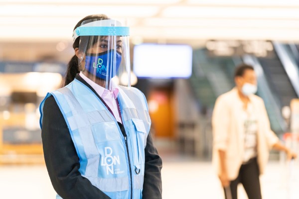 airport staff with mask visor in pandemic