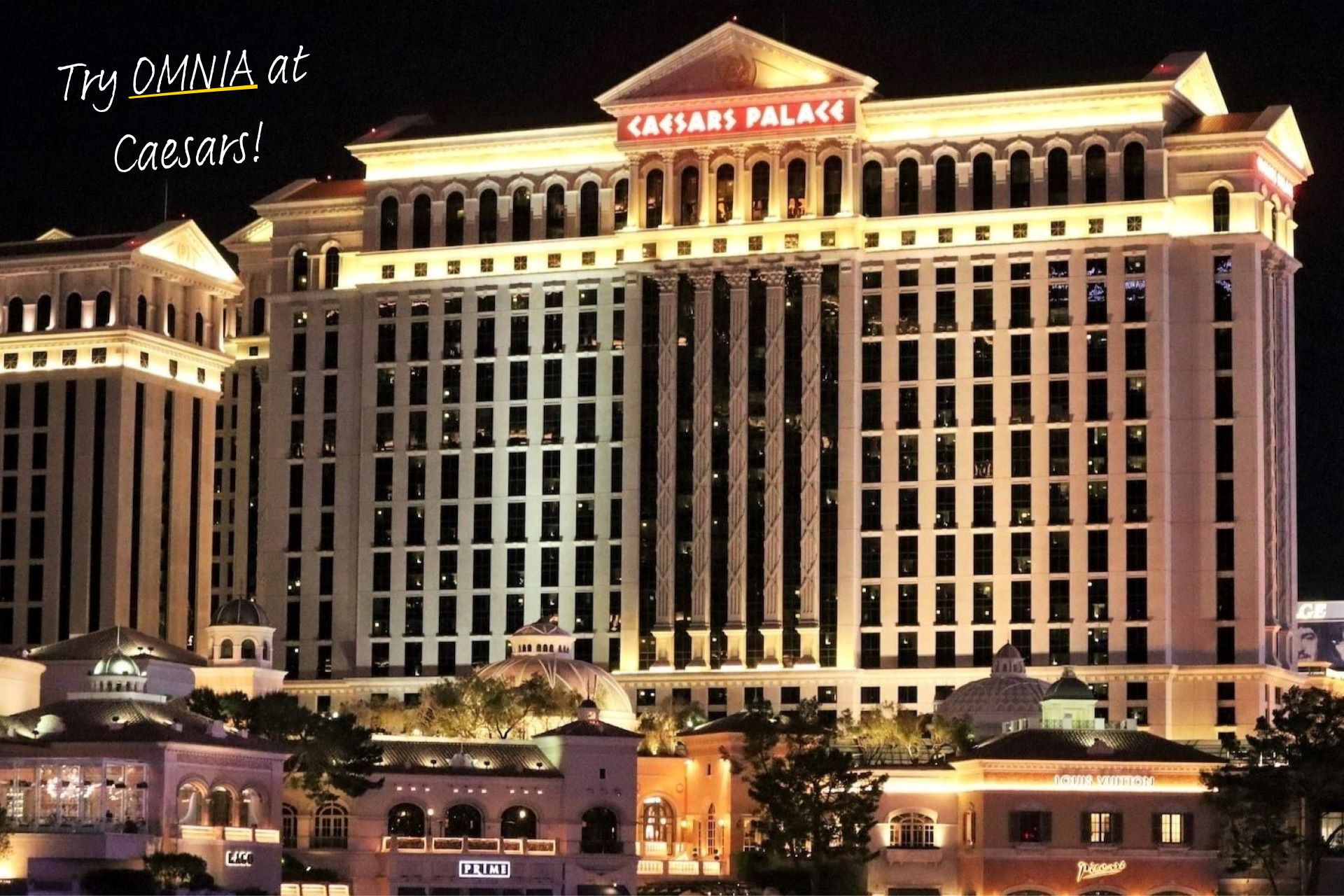 Caesars Palace lit up at night.