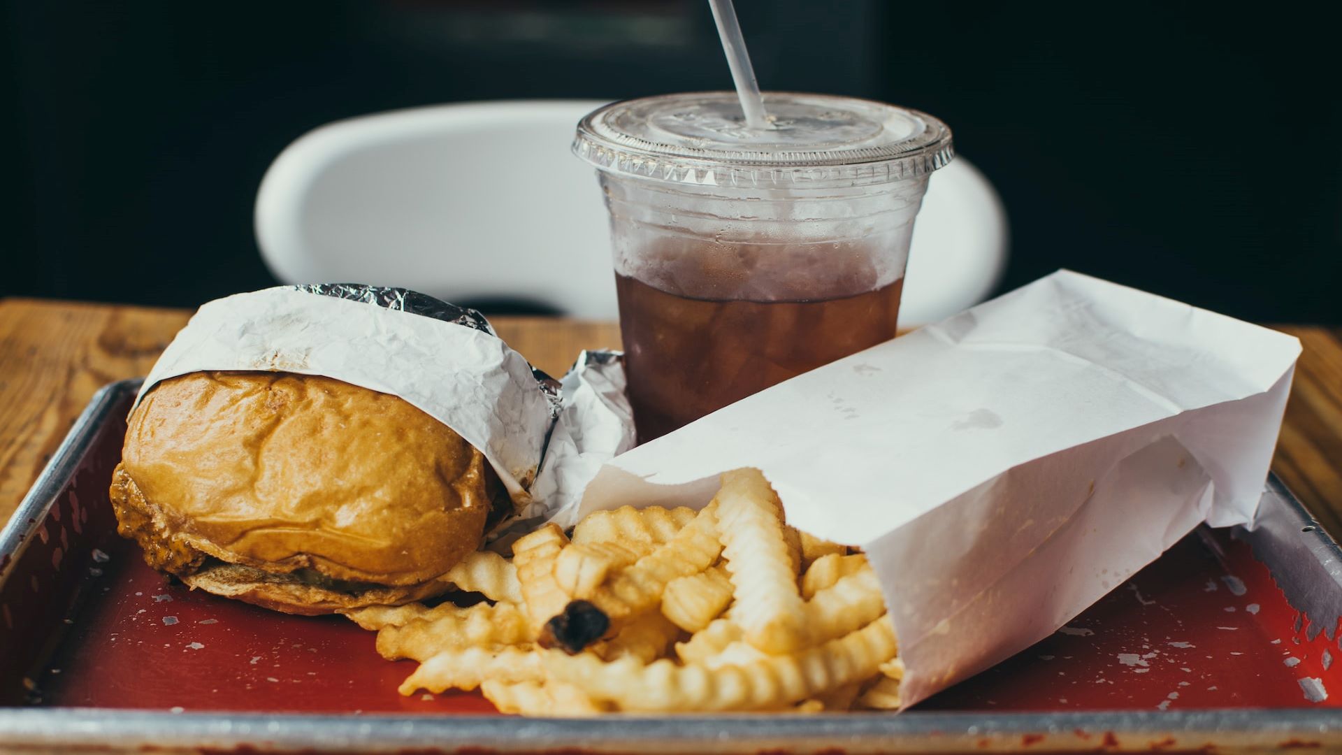 An image of a tray of fast food illustrates what not to eat before a flight.