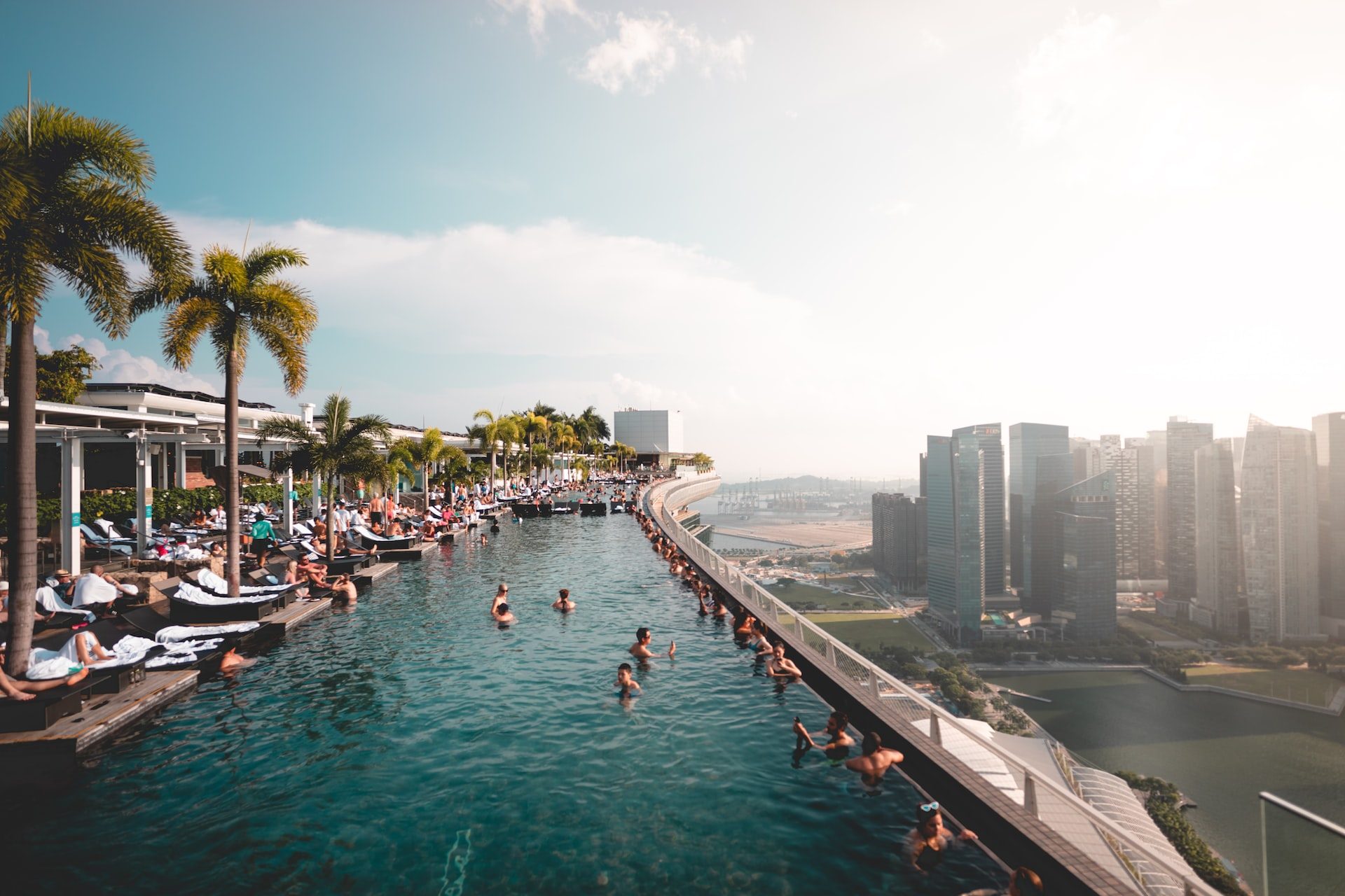 An image of a rooftop pool in Singapore, with a view looking out over the city.