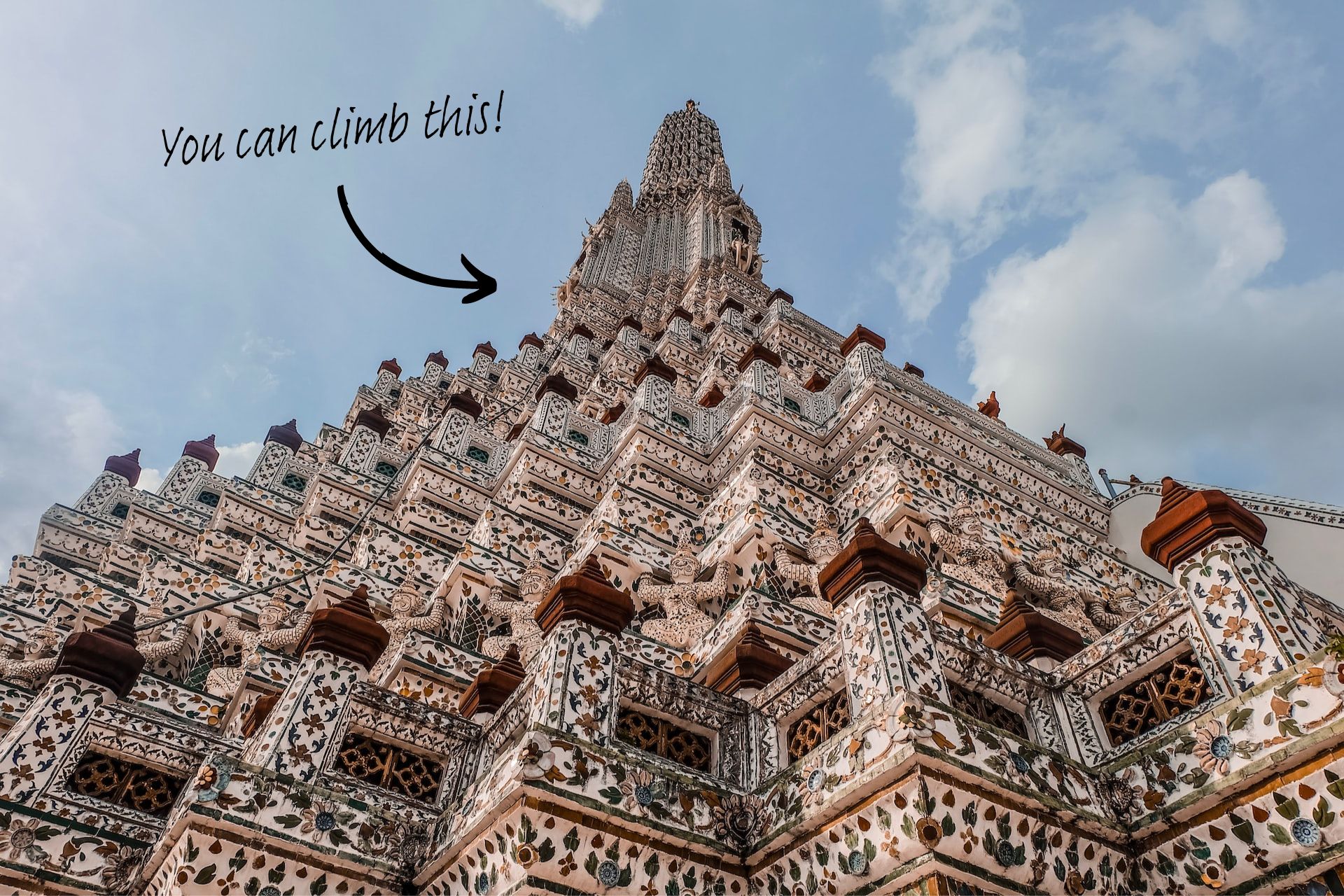 What to expect on your first trip to Bangkok: A picture of Wat Arun, with the words 'You can climb this!' written above it.