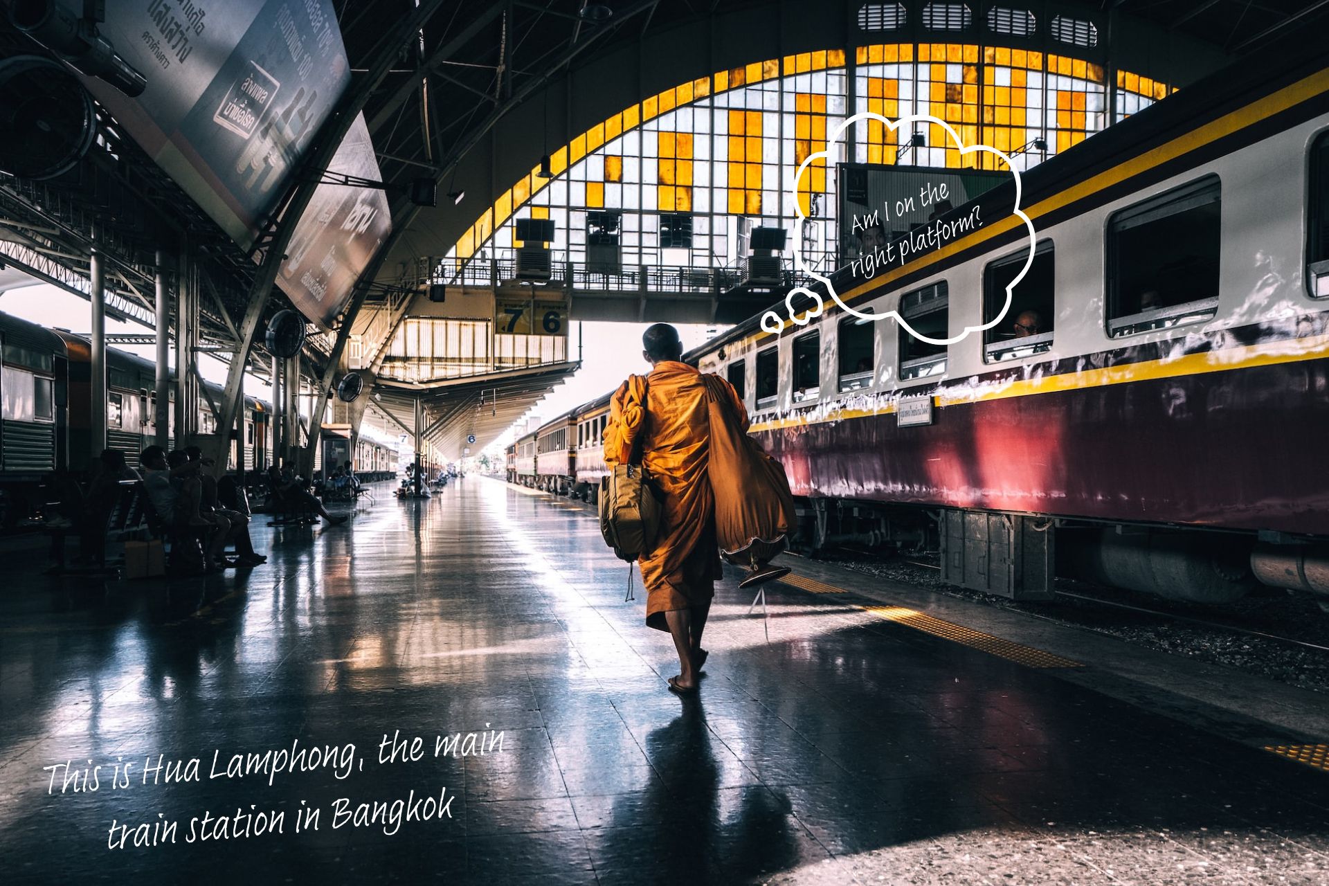 Hua Lamphong train station in Bangkok. A thought bubble rises above a monk's head and says, 