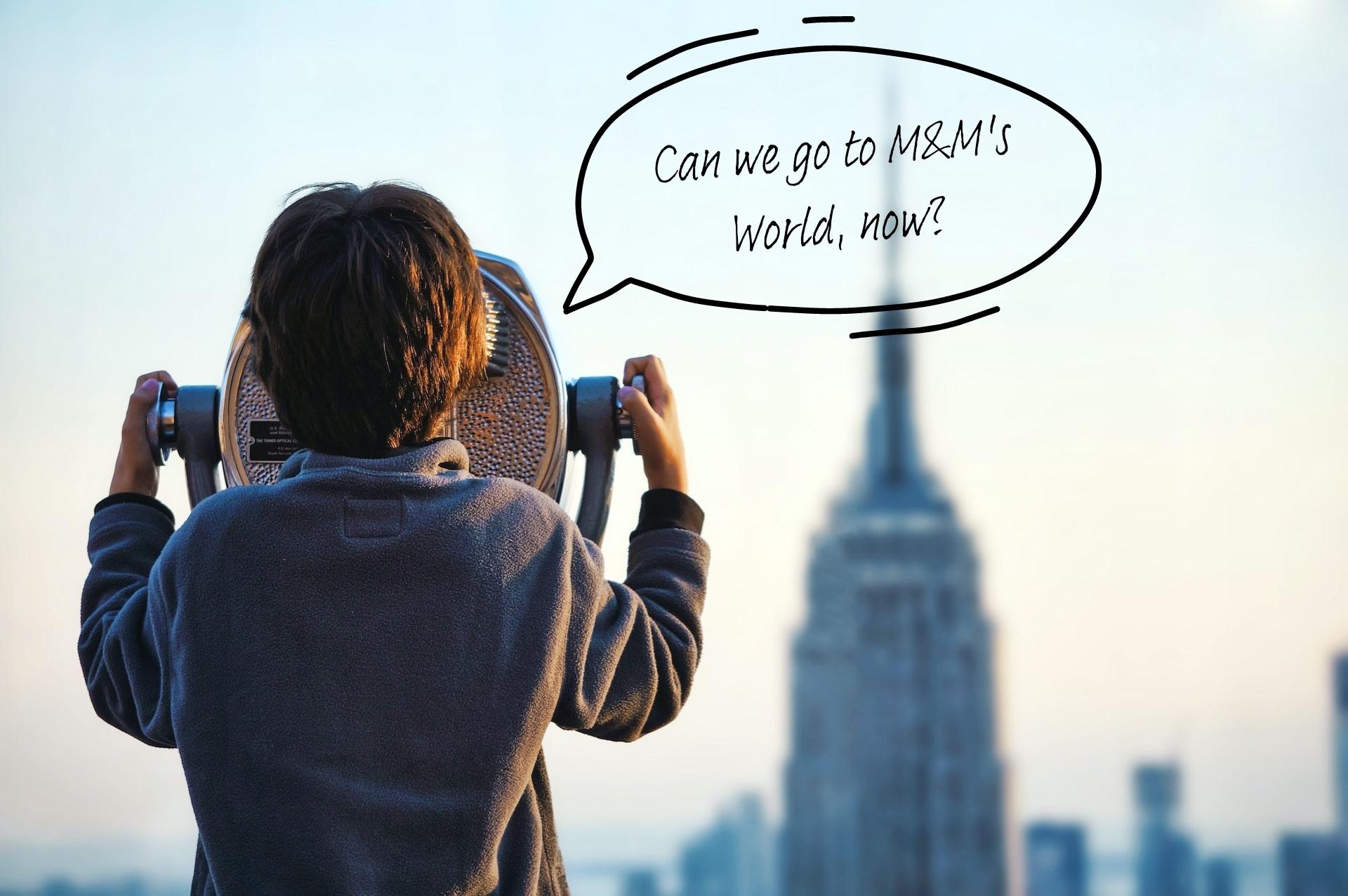 A child looks through a viewfinder at the Top of the Rock in New York.