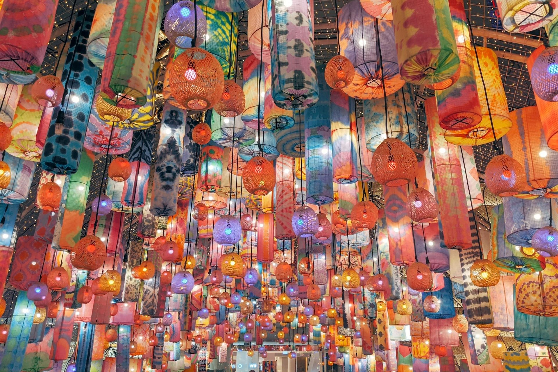 Colourful lanterns hang from a ceiling in Bangkok.