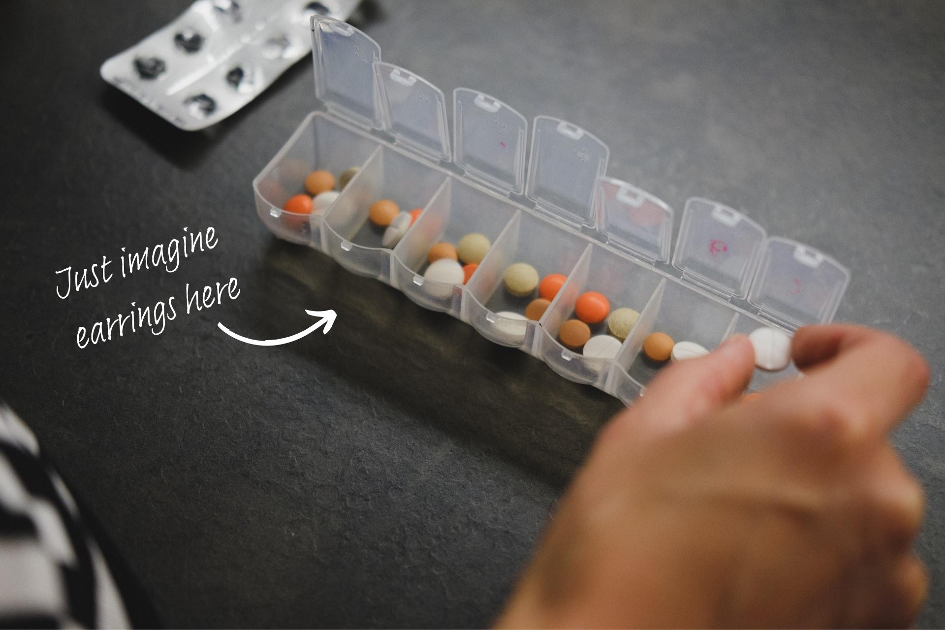 Daily pillbox with handwriting pointing to the box, saying "Just imagine earrings here."