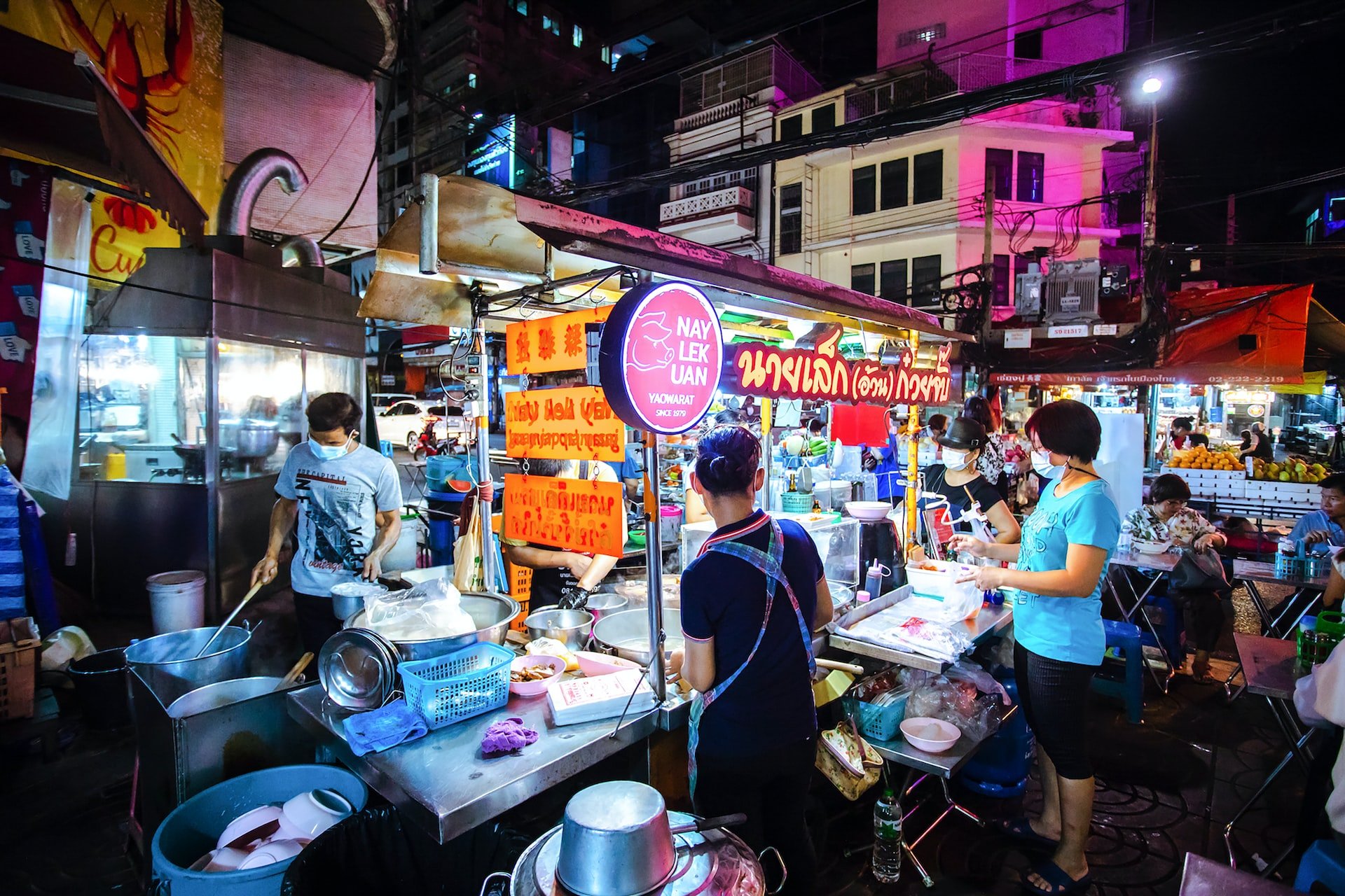 A street food scene in Bangkok at night.
