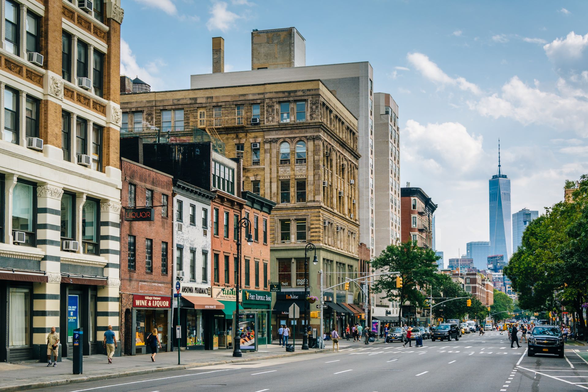 A street in Greenwich Village, an area of New York. Downtown is in the far distance, with skyscrapers reaching into the sky.