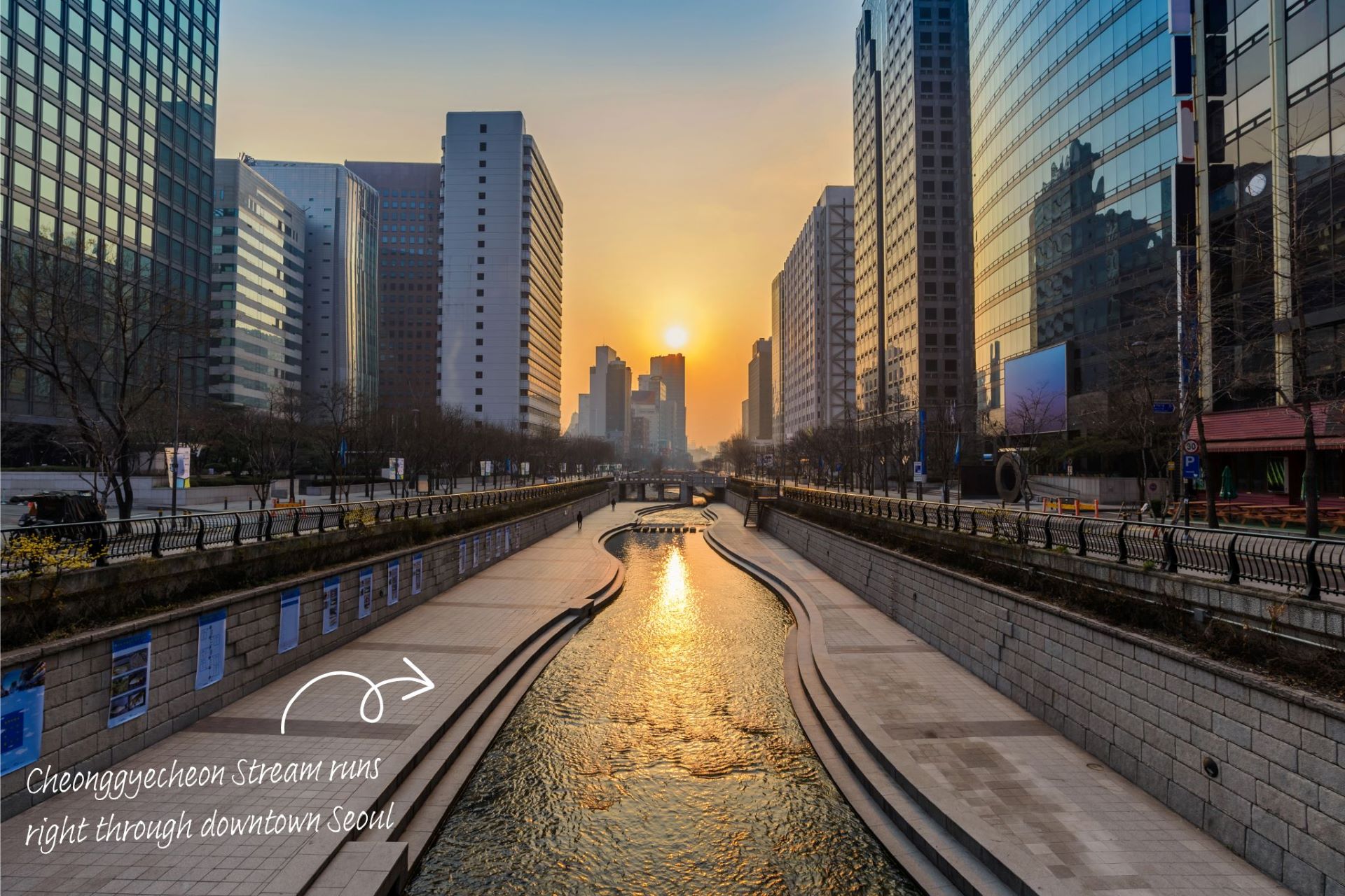 Cheonggyecheon Stream at sunrise, running through the centre of Seoul, high rises either side.
