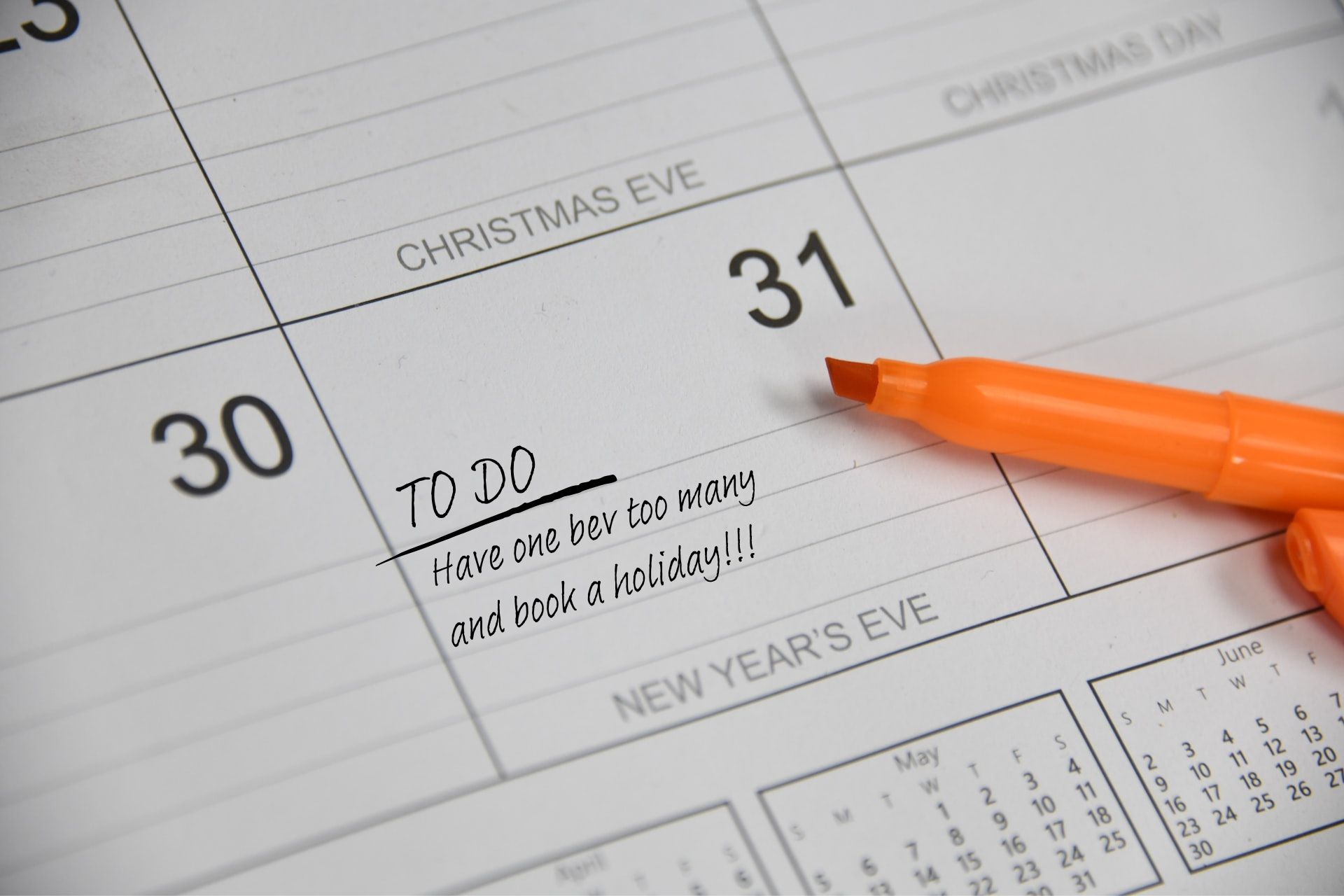 A calendar is open to the 31st of December, New Year's Eve.