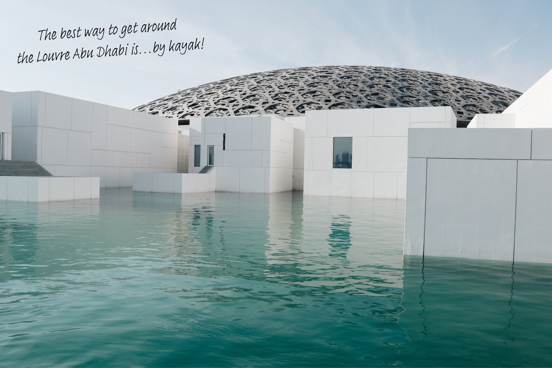 The dome of the Louvre Abu Dhabi, surrounded by water.