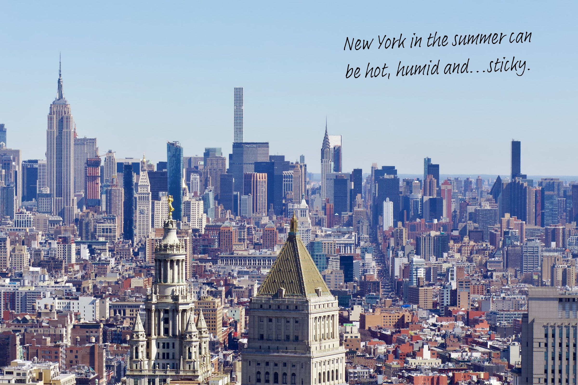 A hazy skyline of New York, big blue sky and skyscrapers.