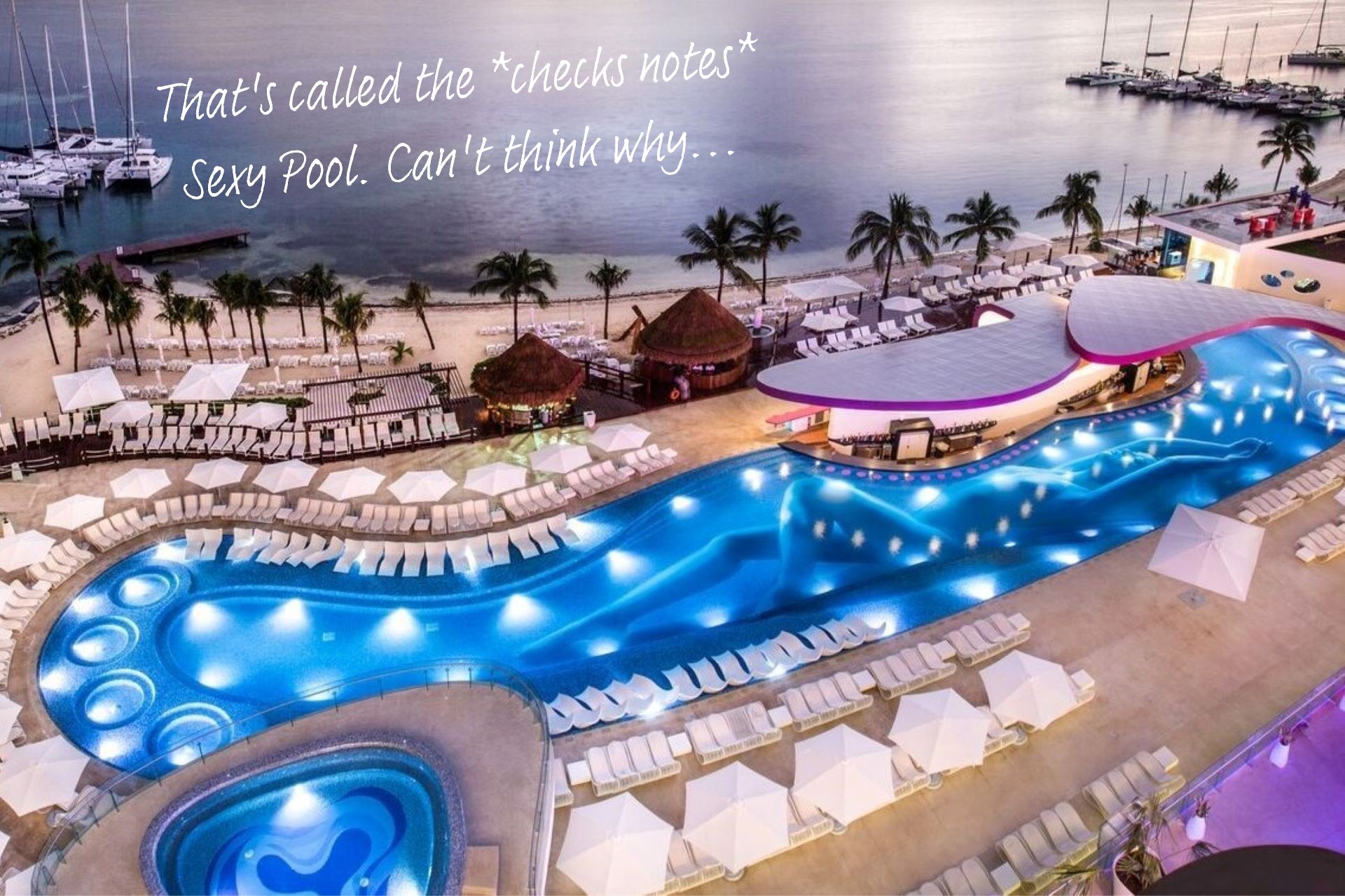 A bird's eye view of the Sexy Pool at Temptations Resort Cancun, famous for the image of a woman's body that runs along the pool floor.