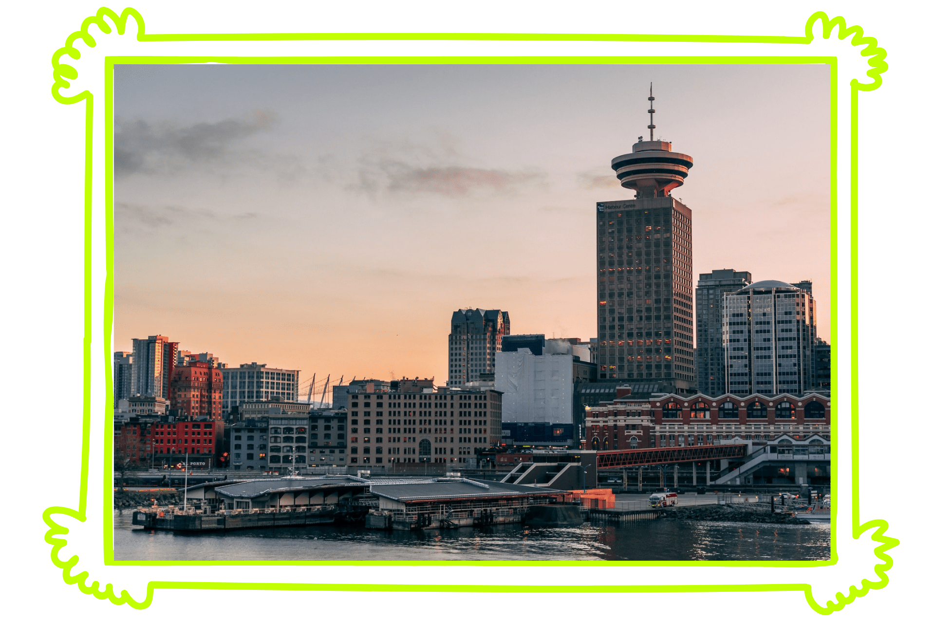 The skyline of Vancouver at sunset, with high rises lining the river.