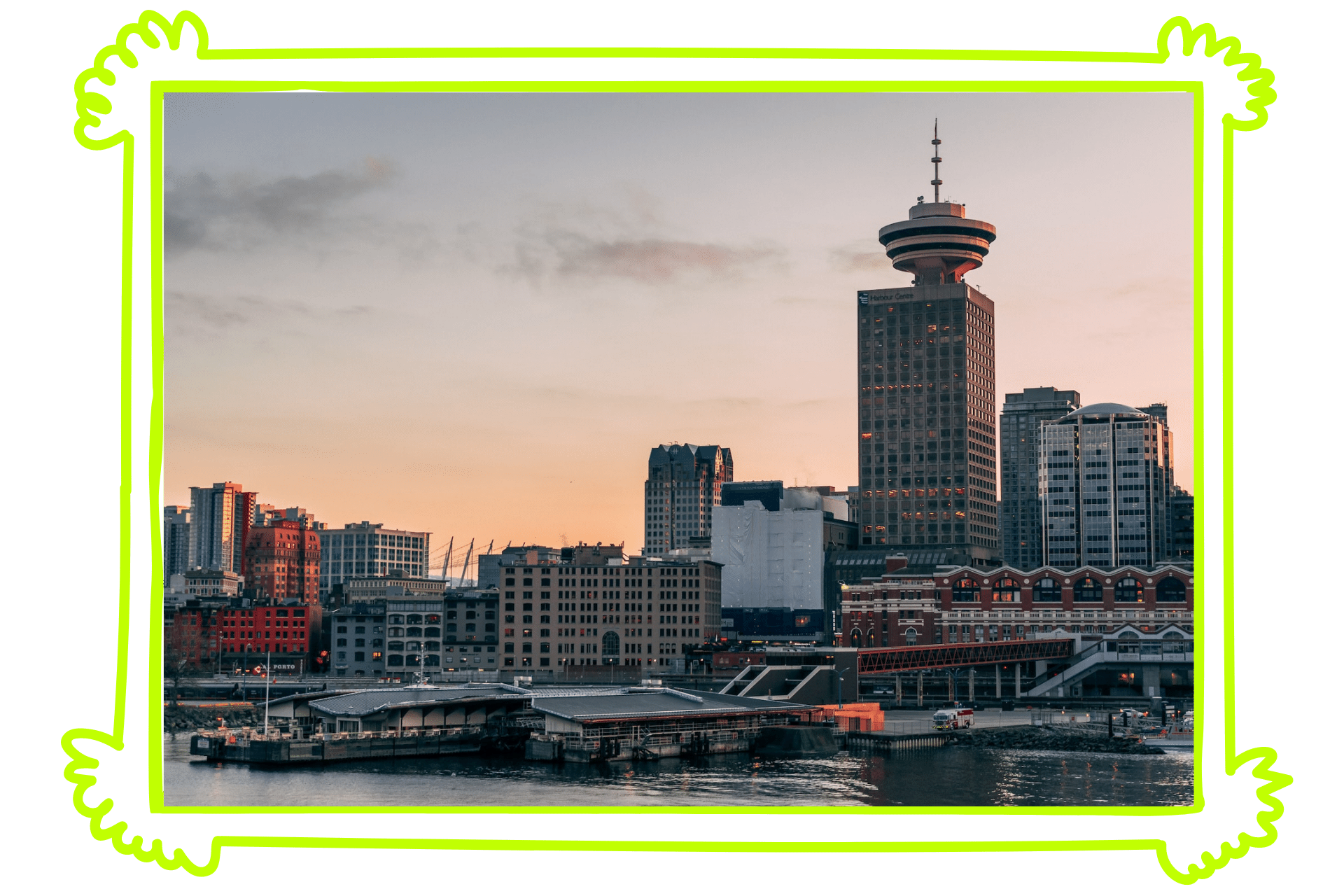 The skyline of Vancouver at sunset, with high rises lining the river.