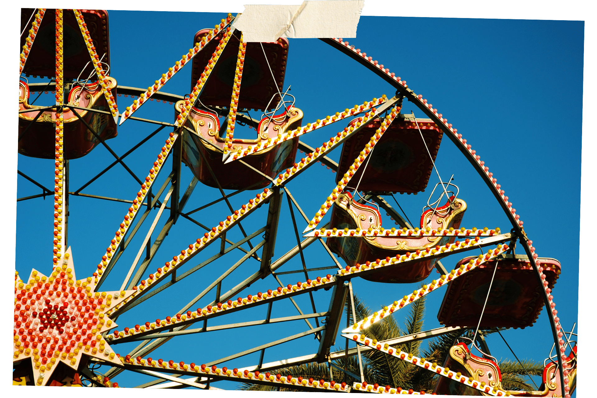 The cabins of a Ferris wheel against a blue sky. Coney Island of one of 10 things to do for all ages.