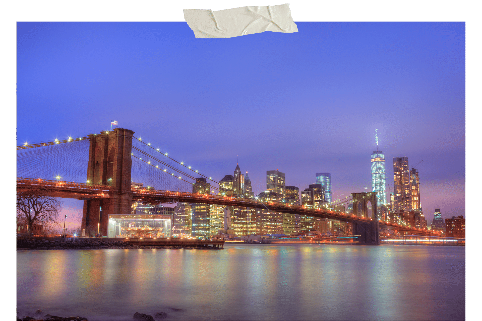 Image shows the Brooklyn Bridge at night, the skyline of New York in the distance.