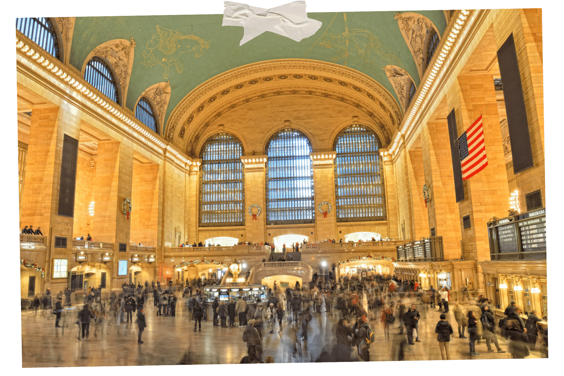 When it comes to New York for Foodies, The Grand Central Oyster Bar is a must. Pictured is the main hall of Grand Central Station in New York, with many commuters moving about and out of focus.