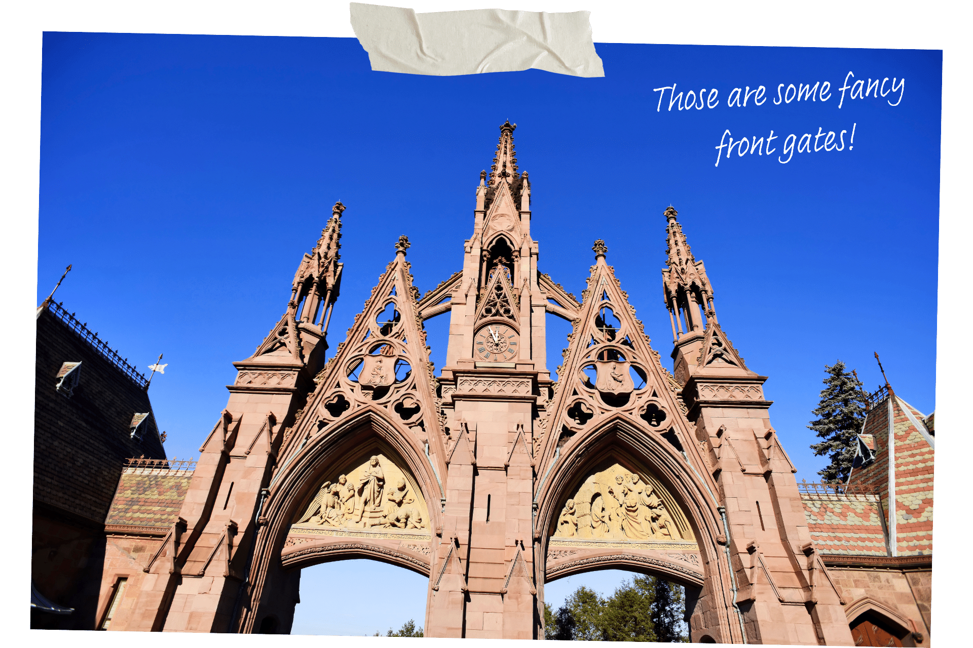 Green-Wood Cemetery is one of the must-visit historic sites in NYC. Image shows the famous Gothic-Revival style stone gates from ground level against a deep blue sky.