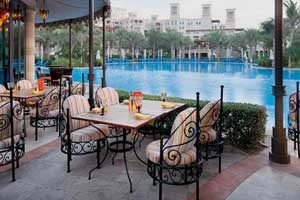 Poolside dining at Dar Al Masyaf